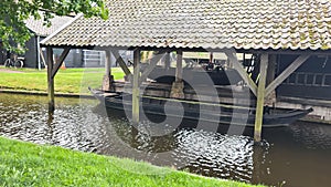 Dutch village with colorful ornamental garden and spring flowers, Giethoorn