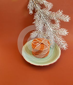 Dutch waffle stroopwafel background cookies round brown pastries plate blue christmas tree white yellow