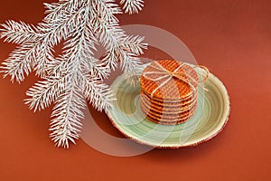 Dutch waffle stroopwafel background cookies round brown pastries plate blue christmas tree white yellow