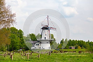 Dutch white windmill and house photo