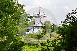 Dutch white windmill and house photo