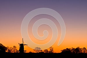 Dutch windmil at sunrise photo