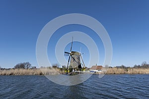 Dutch windmil an UNESCO world heritage site. Stone brick Windmill with water