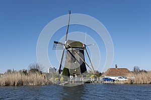 Dutch windmil an UNESCO world heritage site. Stone brick Windmill with water photo