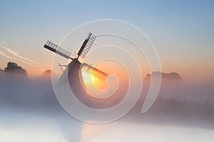 Dutch windmill in dense fog