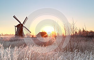 Dutch windmill at frosty winter sunrise