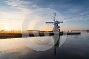 Dutch windmill at a frozen lake.