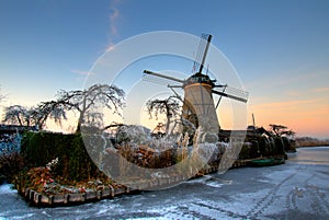 Dutch windmill with garden in the sunset