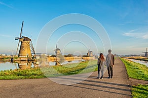 Dutch Windmill landscape at Kinderdijk Village Netherlands with love couple