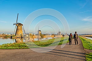 Dutch Windmill landscape at Kinderdijk Village Netherlands with love couple