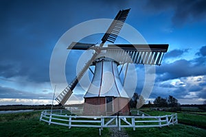 Dutch windmill over storm sky