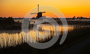 Dutch windmill with photographer in the mist