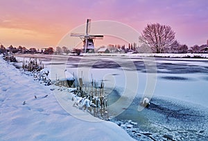 Dutch windmill in the snow of a holland winter