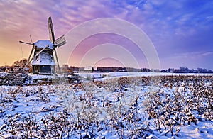 Dutch windmill in the snow of a holland winter