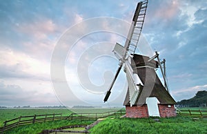 Dutch windmill at summer sunrise