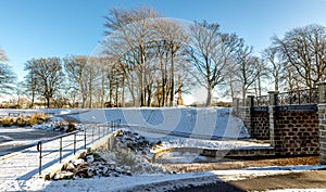 Duthie park in a nice winter day with snow on a ground and a frozen lake, Aberdeen, Scotland