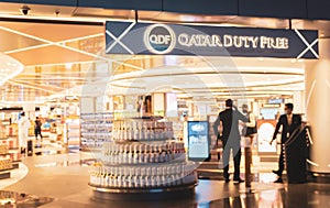 Duty free shop in International Doha airport, soft blurred. Boutiques in airport, defocused. Interior of airport building.