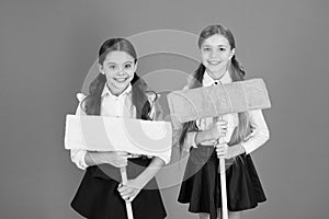 We are on duty today. Pupil cleaning classroom. Nice and tidy. Schoolgirls mop ready for cleaning. School duties. Little