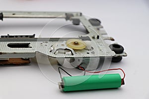 DVD drive disassembled with internal parts visible. Repair concept of dvd motor drive by checking dc motor from external power
