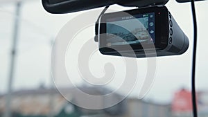 The DVR works in the car. Video recording of the traffic situation while driving. The car is moving along a busy highway