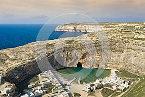 Dwejra is a lagoon of seawater on the island of Gozo. Aerial view of Sea Tunnel near Azure window. Mediterranean sea. Malta