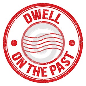 DWELL ON THE PAST text on red round postal stamp sign photo