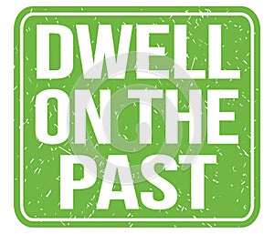 DWELL ON THE PAST, text written on green stamp sign photo