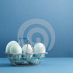 Dyed blue Easter eggs in the basket. Easter holiday concept.