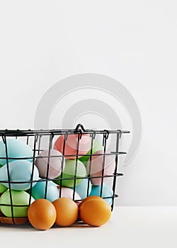 Dyed Easter eggs in the basket. Easter holiday concept.