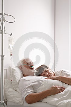 Dying husband in hospital bed photo