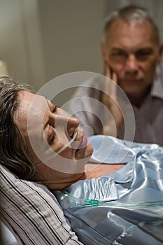 Dying woman in bed with caring man photo