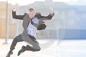 Dynamic businessman jumping outdoor