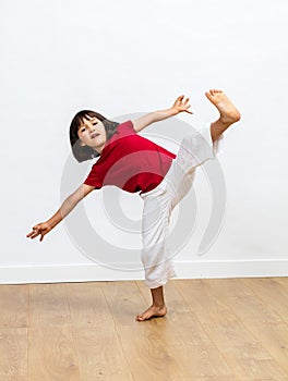 Dynamic child enjoying fighting tai chi, kung fu or taekwondo photo