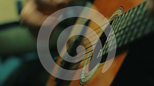 Dynamic Close up shot of handsome man playing guitar