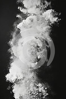 Dynamic Explosion of White Powder Against Black Background