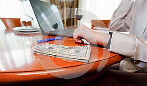 Dynamic female business worker& x27;s hands counting dollar banknotes at the vintage hotel room, stack of dollar bills in