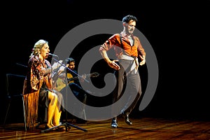 Dynamic Flamenco Trio: Dancer, Singer, and Guitarist on Stage