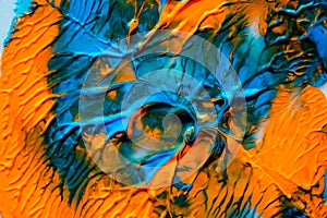 Dynamic fluid color paint splashes background. Blue and orange mixed liquid backdrop. Abstract marbling effect. Dynamic fluid