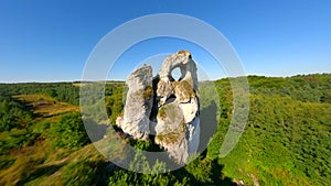 Dynamic FPV flight through hole in the limestone rock of the Jurassic highlands