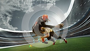 Dynamic image of two men, professional american football players in motion during game at open air 3D stadium at daytime