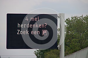 Dynamic information panel above motorway A13 with text to do the rememberance day silence at Parking lot