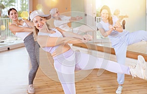 Dynamic middle-aged woman dancing hip-hop