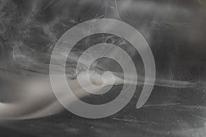 Dynamic photograph featuring swirling smokesteam, with a central object dispersing Concepts energy, transformation photo