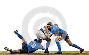 Dynamic portrait of male rugby players playing rugby football on grass field isolated on white background. Sport