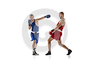 Dynamic portrait of two professional boxer in sports uniform boxing  on white background. Concept of sport