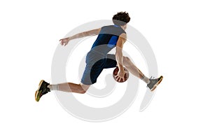Dynamic portrait of young man, basketball player playing basketball isolated on white background. Concept of sport