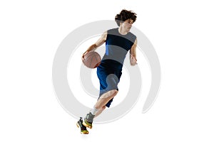 Dynamic portrait of young man, basketball player playing basketball isolated on white background. Concept of sport