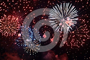 A dynamic scene of red, white, and blue fireworks bursting in the dark sky, A patriotic display of red, white, and blue fireworks