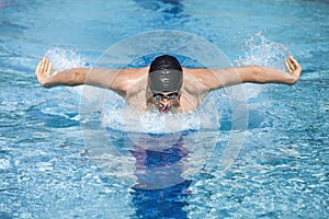 Dynamic swimmer in cap breathing performing the bu