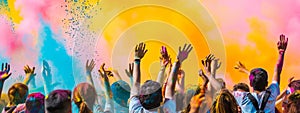 Dynamic wide-angle shot of a colorful powder explosion at a Holi festival with a crowd of happy participants.